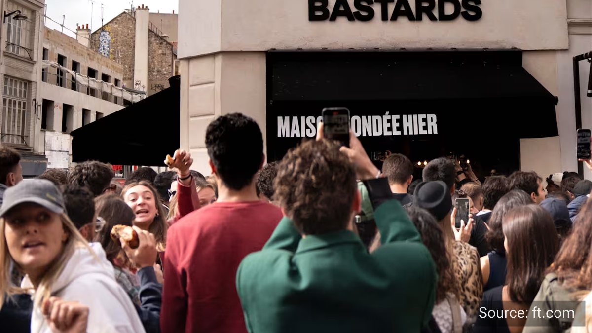 A crowd gathered outside a Paris bakery whose shopfront reads Maison fondee hier.