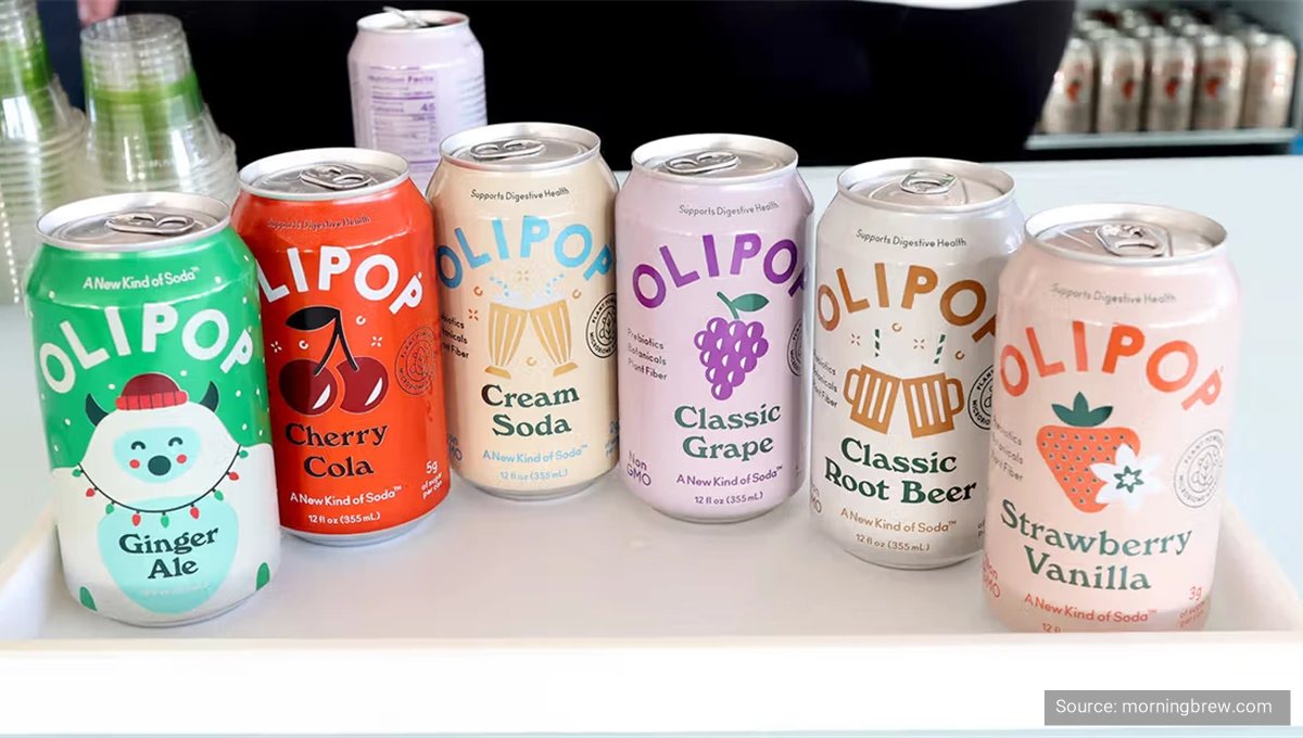 Four Olipop cans in a row: cherry cola, cream soda, classic grape and classic root beer.